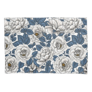 White roses with blue leaves on white pillow case