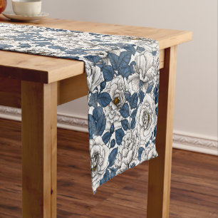 White roses with blue leaves on white short table runner