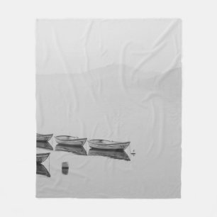 WHITE ROW BOATS INLINE ON BODY OF WATER DURING FOG FLEECE BLANKET
