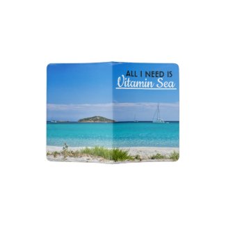 White sand beach with turquoise water and sailboat