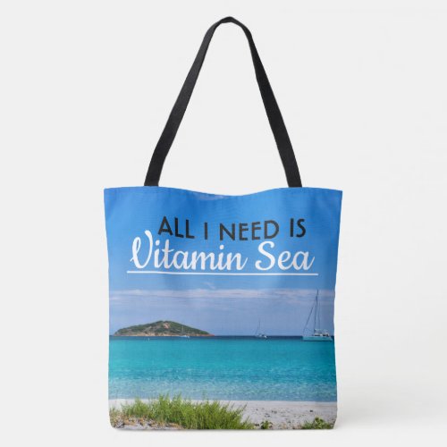 white sand beach with turquoise water and sailboat tote bag