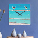 White seagull birds on rope turquoise ocean photo square wall clock<br><div class="desc">There’s good vibes all around whenever you check the time on this colorful, photography wall clock. Happy, white and grey seagulls relax on a rope fence set against the vibrant, turquoise ocean. Makes a great housewarming gift! You can easily personalize this wall clock. Please message me with any questions or...</div>