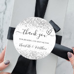 White silver glitter sparkles thank you wedding classic round sticker<br><div class="desc">A chic white background,  decorated with faux silver glitter,  sparkles.  With the text: Thank you for sharing our special day,  with a small heart.   Personalize and add your names.</div>