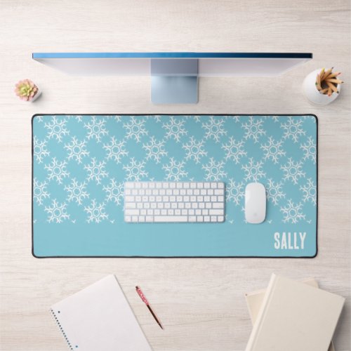 White snowflakes on blue desk mat