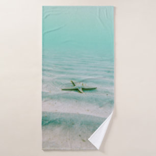 White starfish on sand underwater in the morning bath towel
