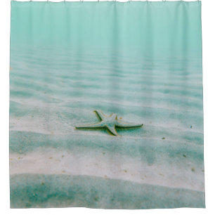 White starfish on sand underwater in the morning shower curtain