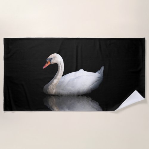 White swan on black beach towel