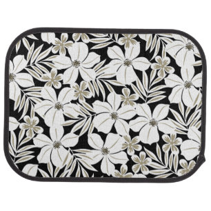 White tropical flowers on black car floor mat