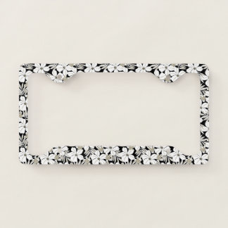 White tropical flowers on black license plate frame