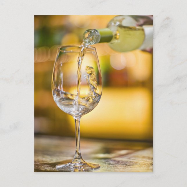 White wine is poured from bottle in restaurant. postcard (Front)