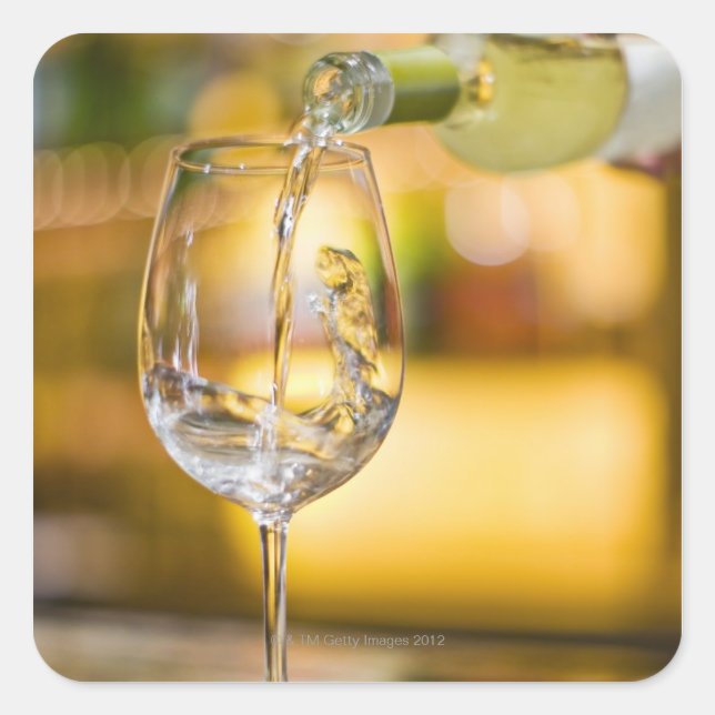 White wine is poured from bottle in restaurant. square sticker (Front)