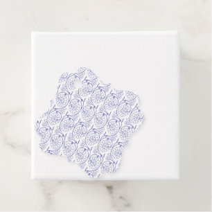 White wrapping paper with a subtle, repeating patt favor tags
