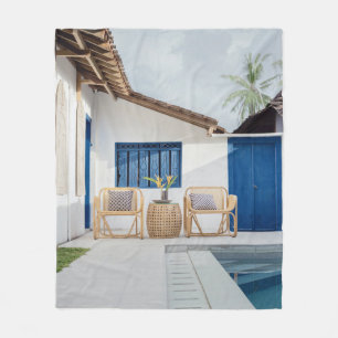 Wicker table and two chairs near swimming pool fleece blanket