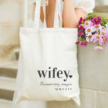 WIFEY | Personalized New Mrs Tote Bag<br><div class="desc">Celebrate the new Mrs. with this cute text-based honeymoon tote design featuring "wifey" in black lettering with a small heart illustration. Personalize with her new name beneath in handwritten-style script,  and the year in Roman numerals.</div>