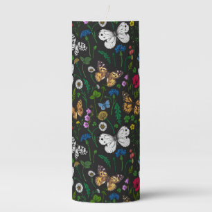 Wild flowers and butterflies on black pillar candle