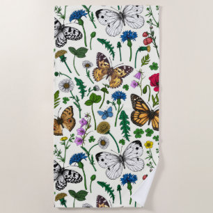 Wild flowers and butterflies on white beach towel