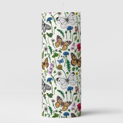 Wild flowers and butterflies on white pillar candle