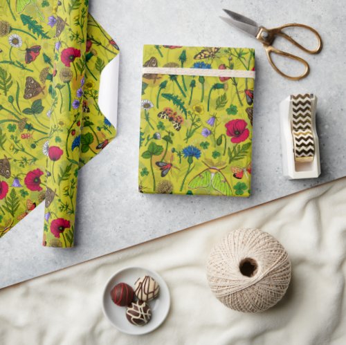 Wild flowers and moths on green wrapping paper
