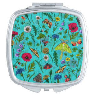 Wild flowers and moths on teal compact mirror