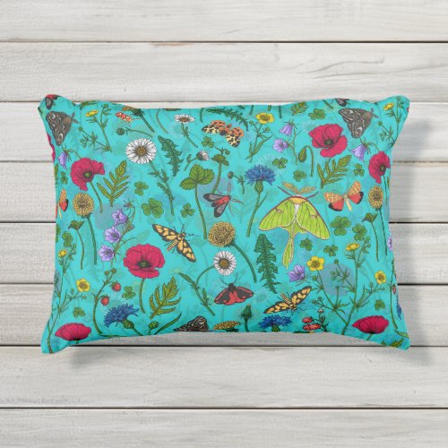 Wild flowers and moths on teal outdoor pillow
