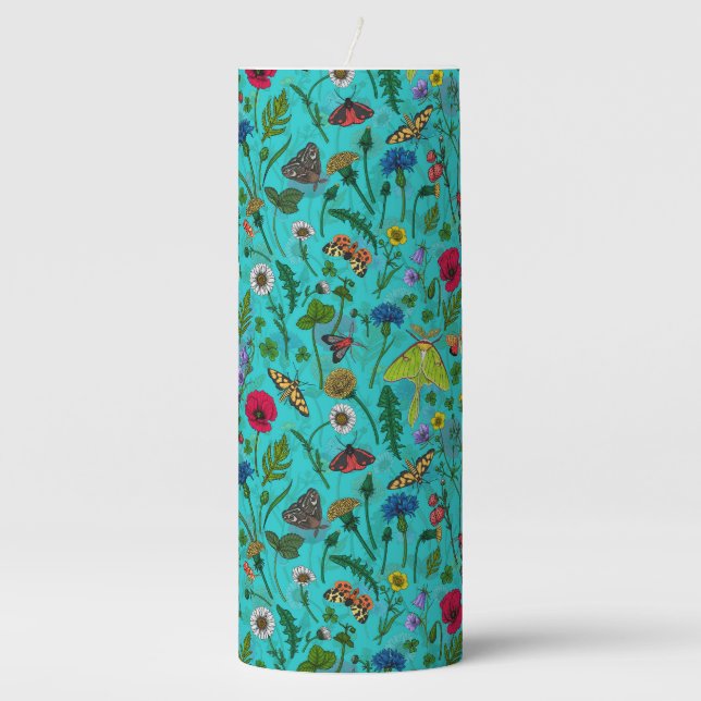 Wild flowers and moths on teal pillar candle (Front)