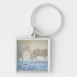 Wild horses running through water keychain