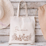 Wildflower Boho Bridesmaid Name Tote Bag<br><div class="desc">Elevate your bridesmaid proposal or thank-you gesture with our charming Wildflower Boho Bridesmaid Name Tote Bag! Crafted with love and adorned with intricate floral designs, this tote bag perfectly captures the essence of bohemian elegance. Each bag is personalized with your bridesmaid's name, adding a thoughtful touch that celebrates her unique...</div>