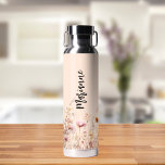 Wildflowers peach beige custom name script water bottle<br><div class="desc">A peach colored background. Decorated with wildflowers in beige,  cream and pink.  Personalize and add your name.  Black handwritten style script.</div>