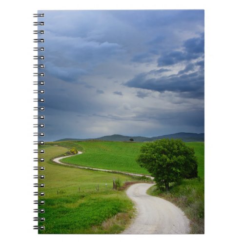 Winding road under a dark sky notebook