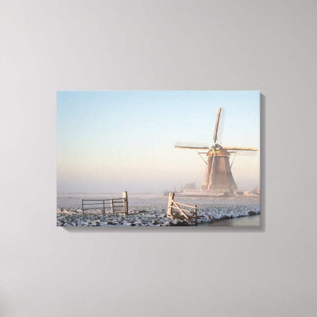 Windmill in the snow at sunrise canvas print (Front)