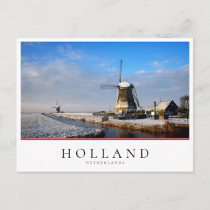 Windmill in the snow in a dutch winter landscape postcard