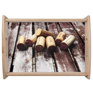 Wine bottle corks on rustic wood texture serving tray