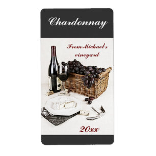 Wine bottle, wine glass, grapes and cheese label