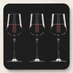 Wine glasses with red wine on black beverage coaster