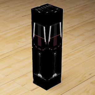 Wine glasses with red wine on black box