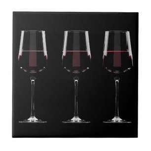 Wine glasses with red wine on black ceramic tile