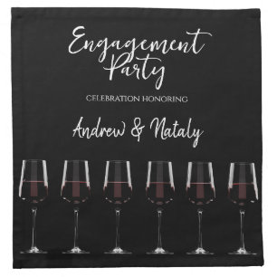 Wine glasses with red wine on black cloth napkin