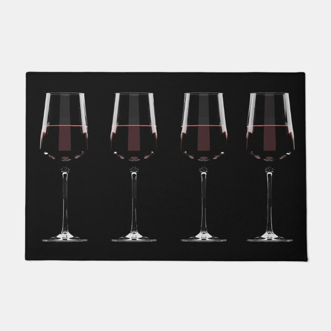 Wine glasses with red wine on black doormat (Front)