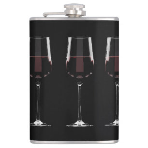 Wine glasses with red wine on black flask
