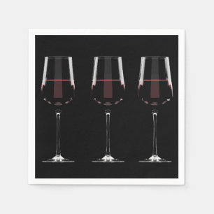 Wine glasses with red wine on black napkins