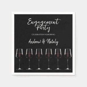 Wine glasses with red wine on black napkins