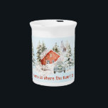 Winter House Vintage Car Home is Where the Heart  Beverage Pitcher<br><div class="desc">A cozy winter scene with a red house surrounded by snow-covered trees. In the foreground, there is a vintage blue car with a wreath on the front with the word "Christmas", and the license plate reads "DEC." The sky is light blue with falling snowflakes. At the bottom of the image,...</div>
