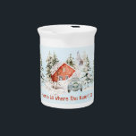 Winter House Vintage Car Home is Where the Heart  Beverage Pitcher<br><div class="desc">A cozy winter scene with a red house surrounded by snow-covered trees. In the foreground, there is a vintage blue car with a wreath on the front with the word "Christmas", and the license plate reads "DEC." The sky is light blue with falling snowflakes. At the bottom of the image,...</div>
