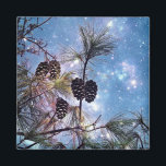 Winter Pine Cones under a starry night sky Magnet<br><div class="desc">An ethereal magical image with an up close view of a pine tree and its branches with many pine cones grouped together. The night sky is a combination of enchanting blues and purples swirling together with ethereal luminous formations and bright twinkling stars shining up above.</div>