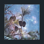 Winter Pine Cones under a starry night sky Magnet<br><div class="desc">An ethereal magical image with an up close view of a pine tree and its branches with many pine cones grouped together. The night sky is a combination of enchanting blues and purples swirling together with ethereal luminous formations and bright twinkling stars shining up above.</div>