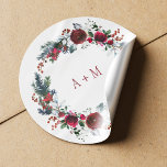 Winter red burgundy peonies wedding monogram classic round sticker<br><div class="desc">Elegant round sticker with a red burgundy and white botanical peony flowers wreath with pine green seasonal fir branches, red berries and foliage and with bride's and groom's initials. Please note that the background color is editable. You can change it after selecting CUSTOMIZE option. ----- Suitable for winter / Christmas...</div>