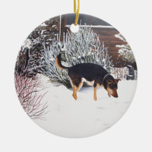 Winter snow scene with cute black and tan dog ceramic ornament