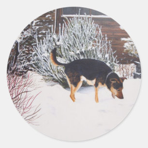 Winter snow scene with cute black and tan dog classic round sticker