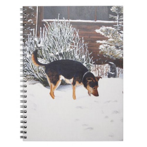 Winter snow scene with cute black and tan dog notebook