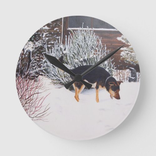 Winter snow scene with cute black and tan dog round clock